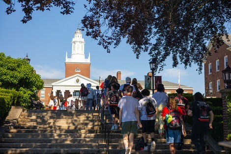 A group of students walking up stairs 