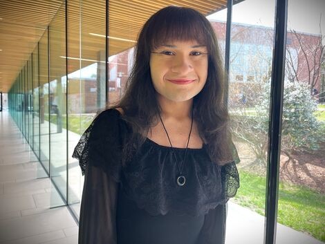 A woman wearing black smiles for the camera 