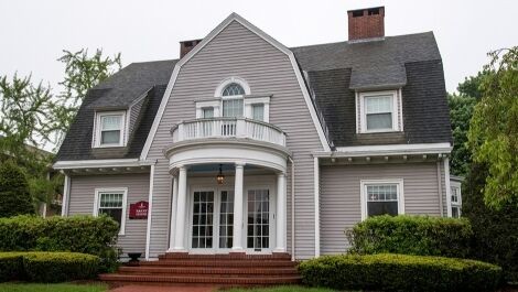 Exterior of the Barry House with brick steps and landscaping in front.