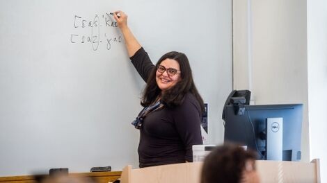 Fernanda Ferreira writes on a white board while teaching a class.