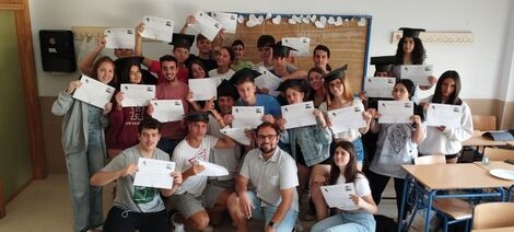 A man sits in the middle of a group of students 