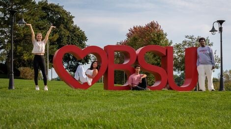 Four students pose by a red Heart BSU sculpture.