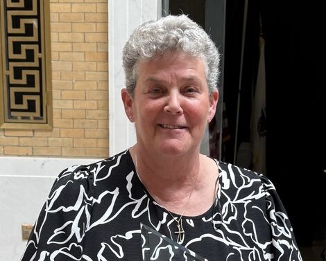 a woman with gray hair smiles 