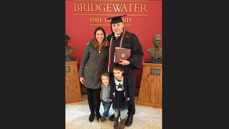 Weston Smith with his family in front of a BSU sign.