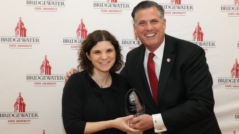 Caroline Stanley receives an award from President Clark.