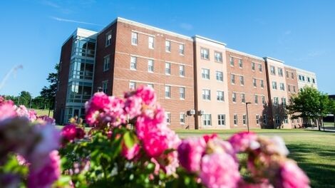 The exterior of Stonehouse Hall with flowers in the foreground.