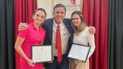 Kelsey and Elisabeth Sweeney receive sorority awards from President Clark.