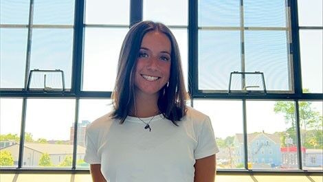 Nora Sperling stands in front of windows.