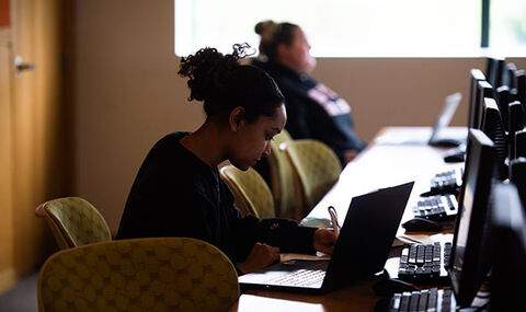 A student takes notes in political science class