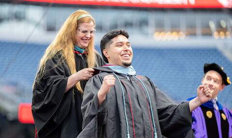 A graduate student is hooded at BSU 2025 Graduate Commencement ceremony