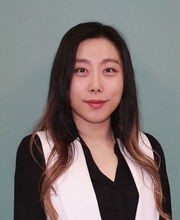 Dr. Hannarae Lee smiling with long straight dark hair and wearing a black and white blouse