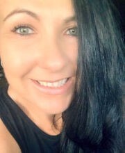 Jessica Melendy smiling with long straight dark hair and wearing a black tank top