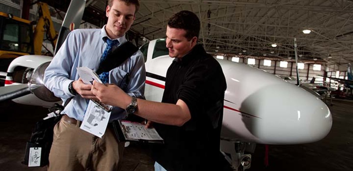 An aviation student and instructor go over last minute instrutions An aviation student and instructor go over last minute instrutions