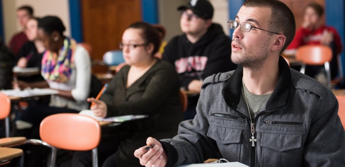 Students in class listening to the professor Students in class listening to the professor