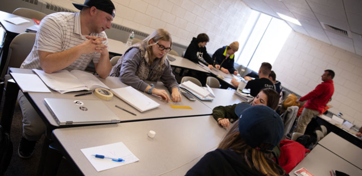 Students take note as they work together to solve a problem put forth by the professor. Students take note as they work together to solve a problem put forth by the professor.