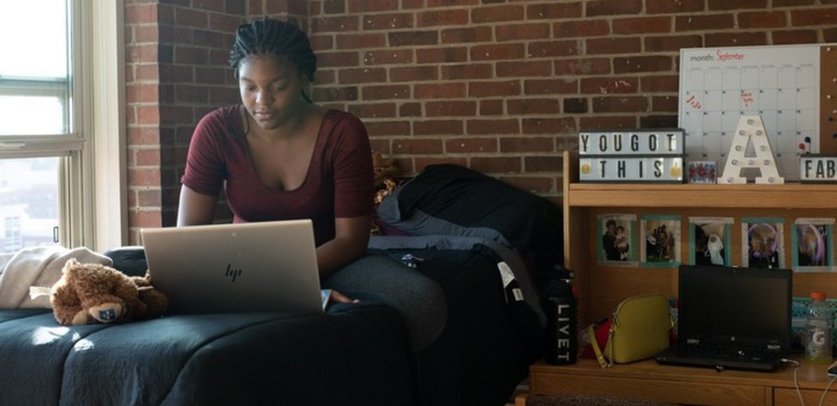 female student in dorm room on laptop female student in dorm room on laptop