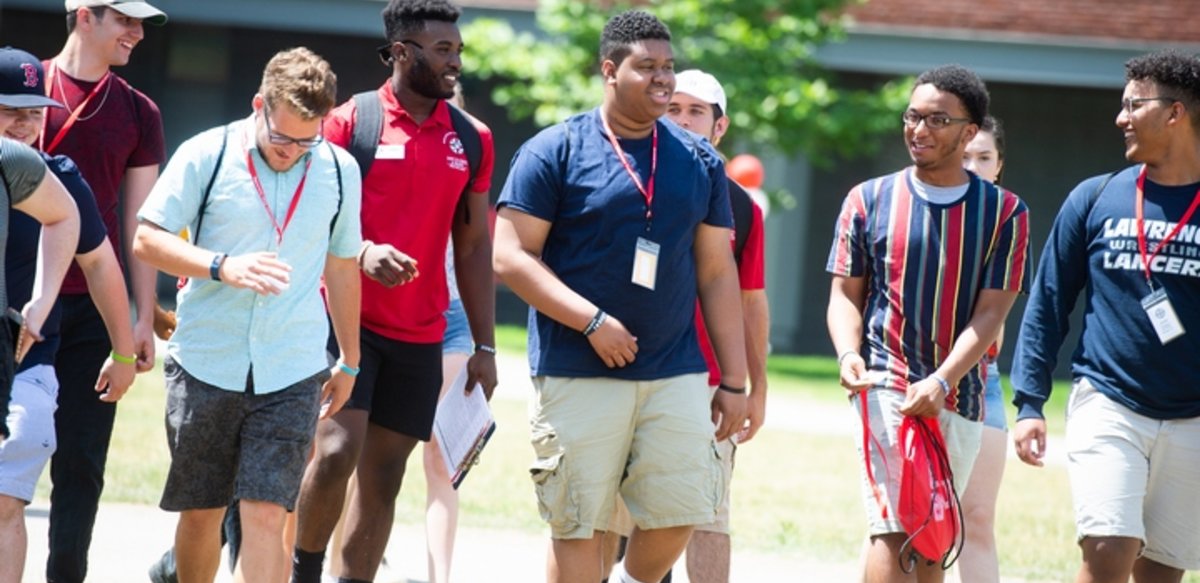 a group of male students walking on campus during Orientation a group of male students walking on campus during Orientation