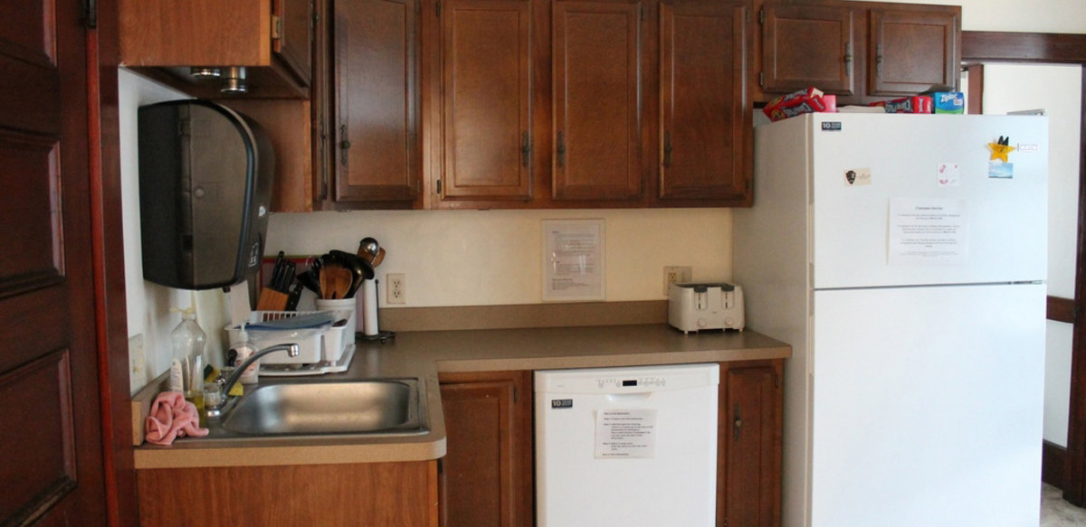 Scholar House kitchen showing refrigerator, dishwasher, toaster, sink, cabinets and counter top