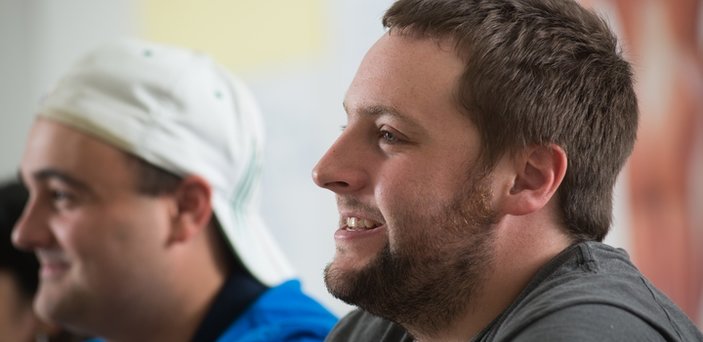 Two male students in class smiling Two male students in class smiling