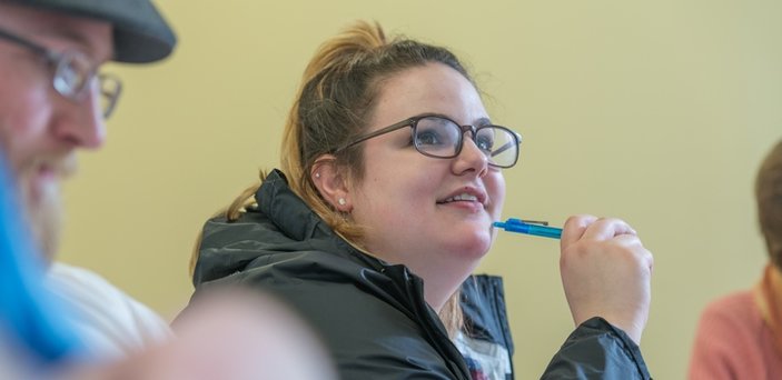 A student participating in class discussion