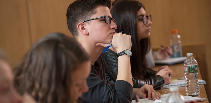 Students in class listening to the professor