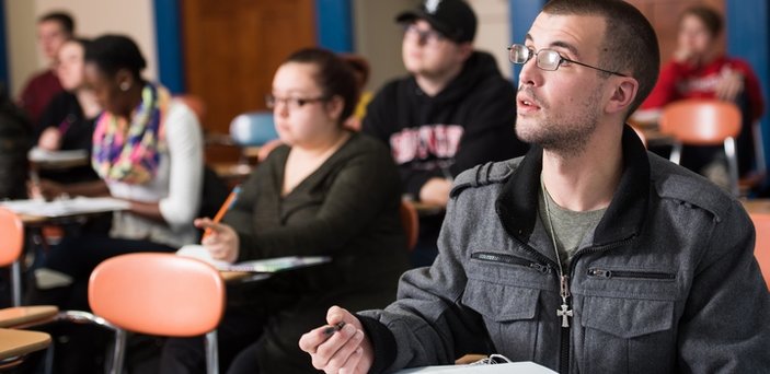 Students in class listening to the professor Students in class listening to the professor