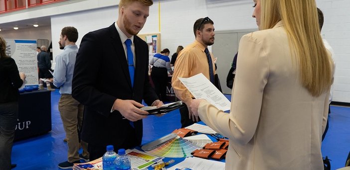 A student meets with an employer at the Job and Internship Fair.