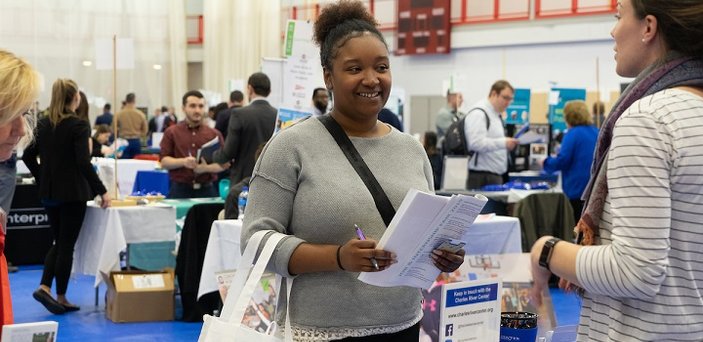 A student meets with an employer at the Job and Internship Fair.