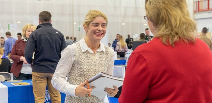 A student meets with an employer at the Job and Internship Fair.
