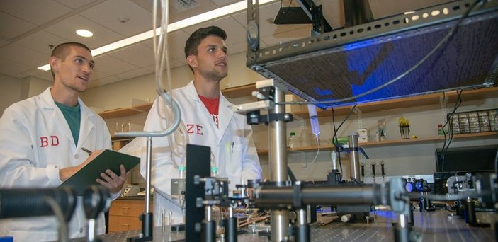 students working in photonics lab students working in photonics lab