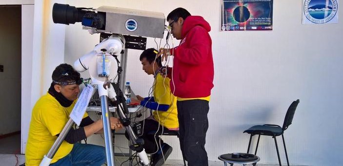 A student adjusts equipment