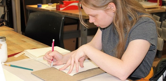 A student works in the book arts program.
