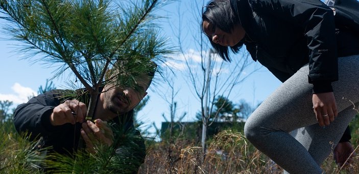 A fire ecology class explores the woods on campus.