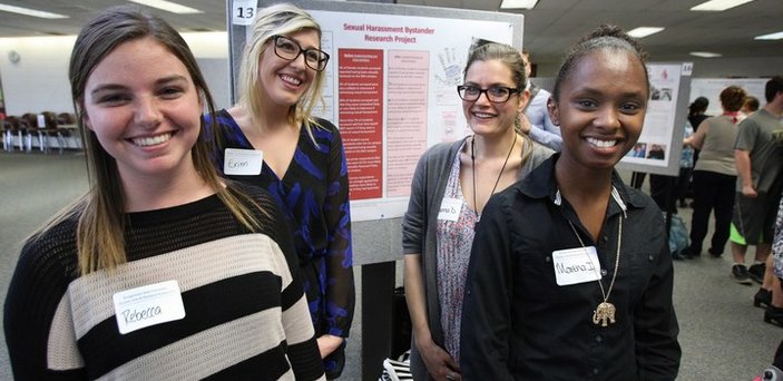 BSU students giving poster presentation on Sexual Harassment Bystander research at spring symposium