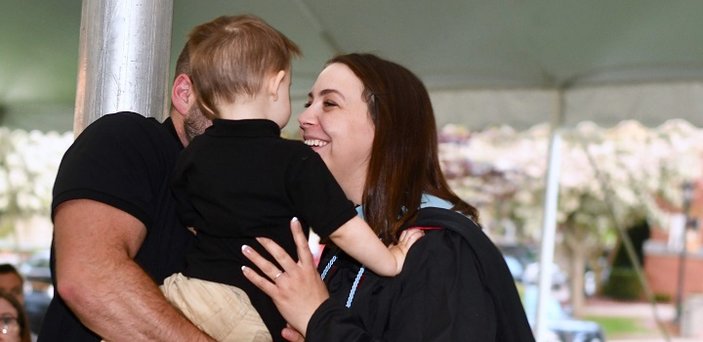 A graduate greets her family.