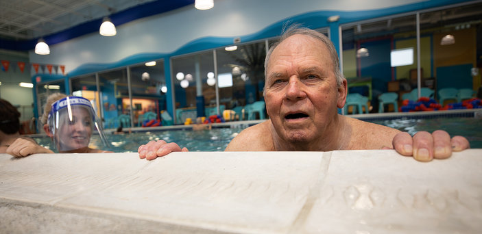 A BSU student works in the pool with a Parkinson's patient.