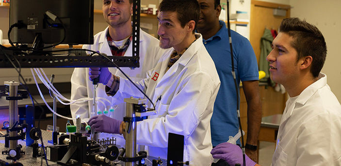 Dr. Thaya Paramanathan with 3 students in BSU's single molecule lab