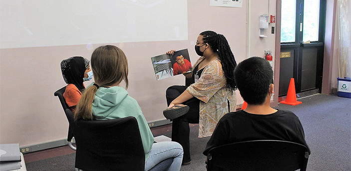 a BSU student reads to elementary school children on Hanscom Air Force base in Massachusetts