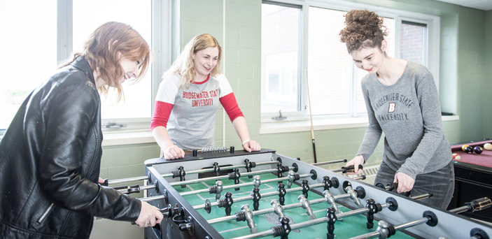 Students play foosball together in the game room