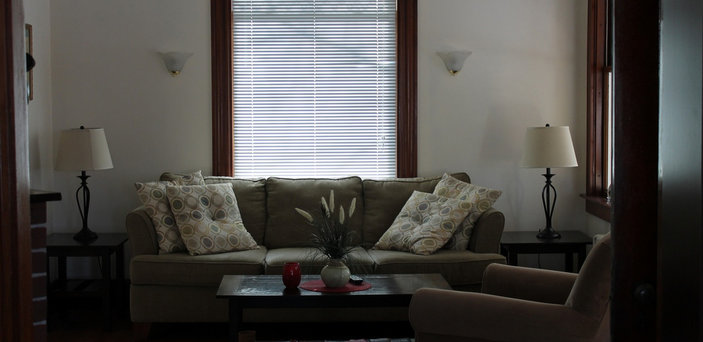 Scholar House living room with couch, chair, coffee table and fireplace