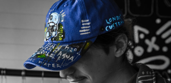 Matt Looks down wearing a blue hat 