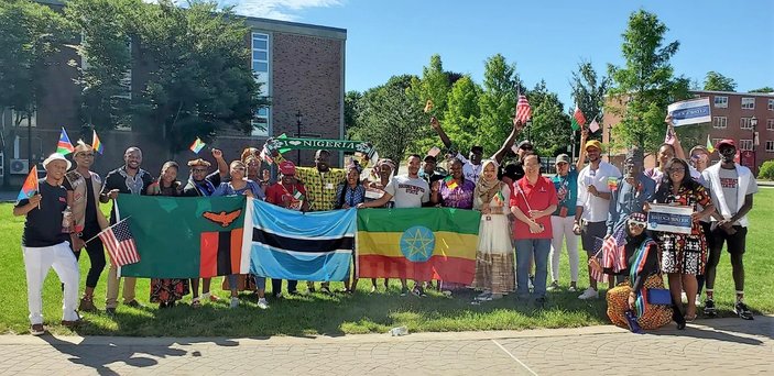Mandela fellows pose for a photo holding country flags.