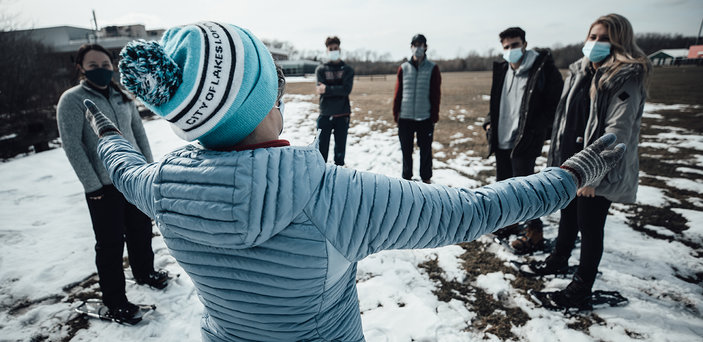 Maura Rosenthal instructs the class in a field.