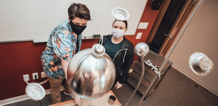 Students demonstrate a Van de Graaff generator.