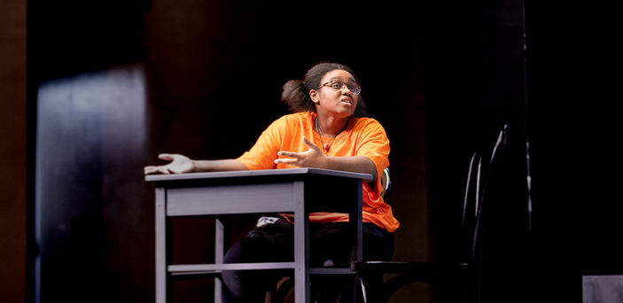 A student sits at a desk.