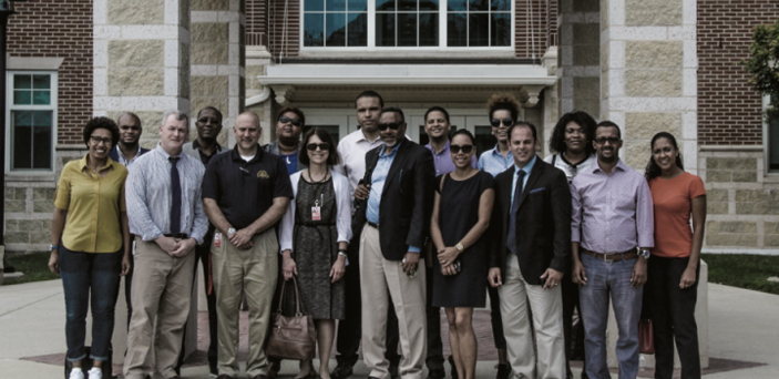 group photo outside brick building