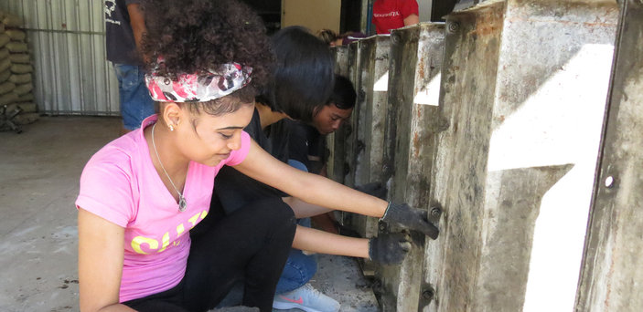 A BSU student installing a water filter in Cambodia