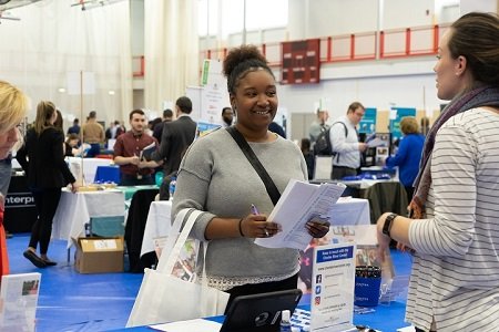 A student meets with an employer at the Job and Internship F A student meets with an employer at the Job and Internship F