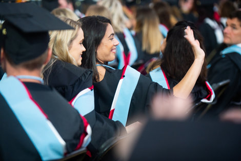 Graduates in the audience during commencement ceremony Graduates in the audience during commencement ceremony