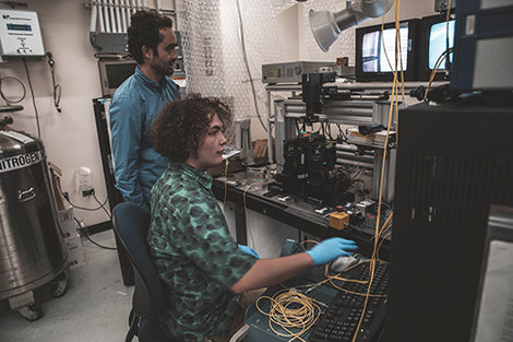 Dr. Samuel Serna and Brahmin Thurber-Carbone work in a lab a Dr. Samuel Serna and Brahmin Thurber-Carbone work in a lab a